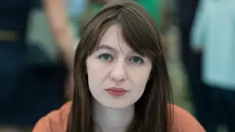 Sally Rooney states she cannot travel to the UK over potential arrest